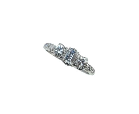 claw set emerald cut diamond, estimated approximate weight 0.33ct, flanked by two round brilliant cut diamonds, average diame