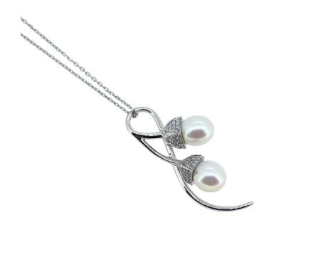stylized acorn pendant set with two oval shaped cultured pearls, each one suspended from a pavé set round brilliant cut diamo