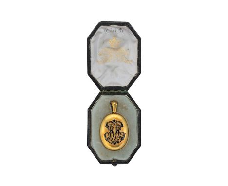oval shaped with a black enamelled monogram in the centre, inside is a black and white photograph of a smartly dressed gentle
