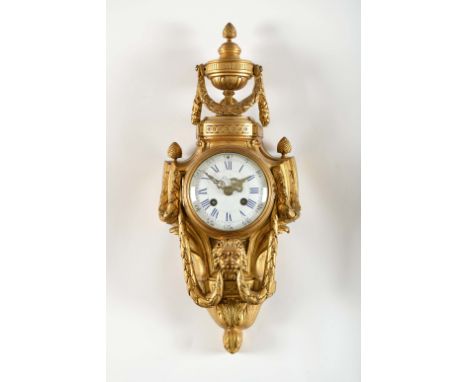 A "Cartel" wall clock, Louis XVI style, gilt bronze en relief "Amphora, Lion's fauces and garlands", white enamel dial with b