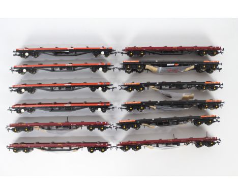 Bachmann - A rake of 12 80T BDA Bolster wagons by Bachmann. Lot includes #38152 in EWS livery x4 - one is missing its stanchi