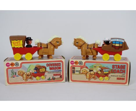 Marx - Two boxed vintage 1997 plastic clockwork toys by Marx. Lot consists of Marx #5490 Covered Wagon with Clockwork Walking