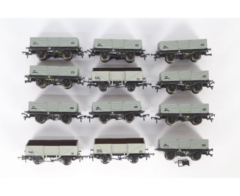 Bachmann, Airfix, Dapol - A rake of 12 unboxed OO gauge plank wagons. Lot includes Bachmann #37-058 13T 5 Plank Open Wagon in