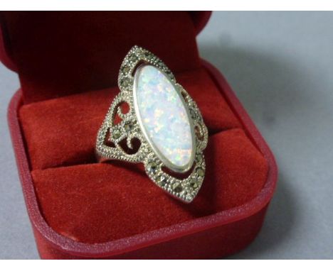 A silver art nouveau style ring set with marcasites and a large opal