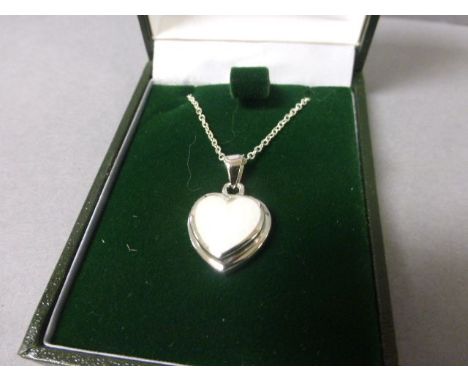 A silver heart shaped opal pendant necklace