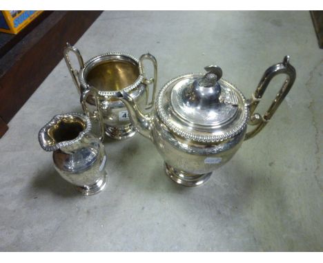 A Victorian silver plated three piece tea set by Martin Hall & Co in the Neo-Classical style, incised with warriors, scholars