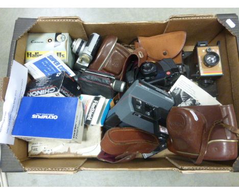 A box of vintage film cameras including a Leica C2-Zoom, Polaroid Impulse AF, and Olympus Trip