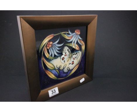 A Moorcroft framed tile, decorated with a buttlerfly and flowers 