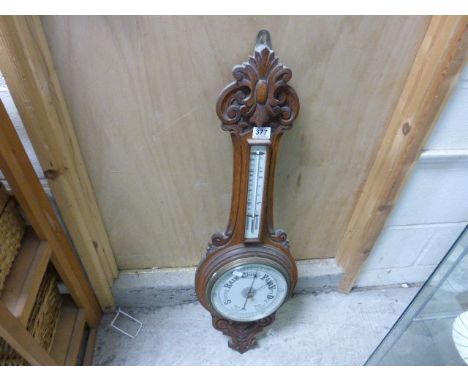 An early 20th century oak cased barometer 
