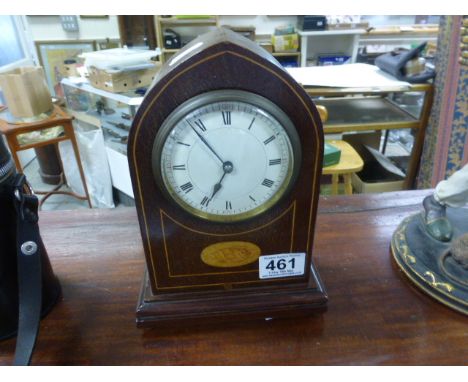 A mahogany cased arched mantel clock with a shell motif, on four bun feet 