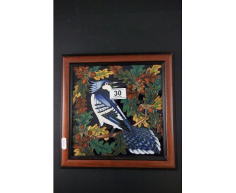 A Moorcroft framed tile of a bird perched on a an acorn branch 
