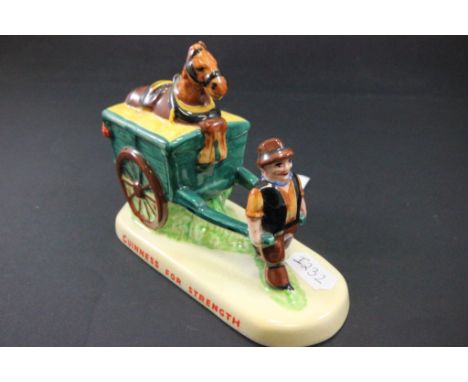 A Carlton Ware Guinness ceramic model of a man walking a cart