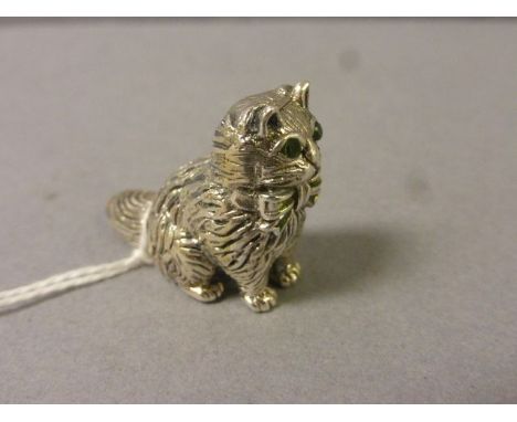 A cast silver cat with emerald eyes