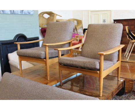 A pair of 1960's Ercol style teak arm chairs (webbing replaced on one)