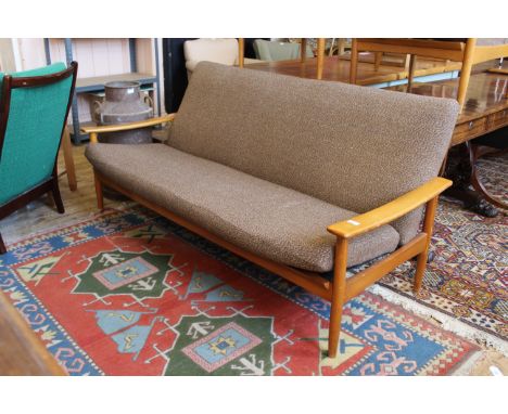 A 1960's Ercol style teak three seater sofa