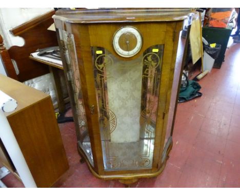 Small china cabinet with clock to the front