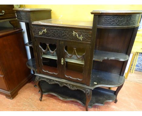 Polished wood display unit with central glazed doors and lower shelf