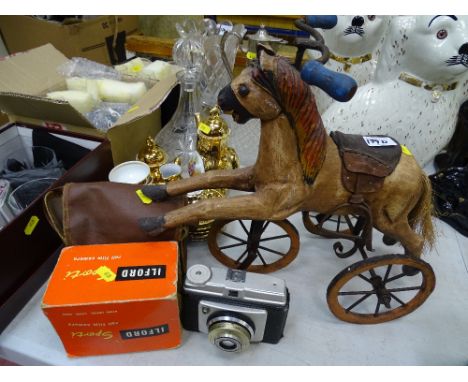 Model wooden horse on a bicycle and a small parcel of vintage cameras