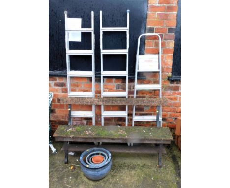 A wooden and metal garden bench, three aluminium step ladders and four planters. (8)