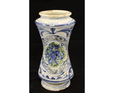A 17th Century maiolica Albarello with blue and white scrolling foliate decoration and stylised flower head decoration, spong