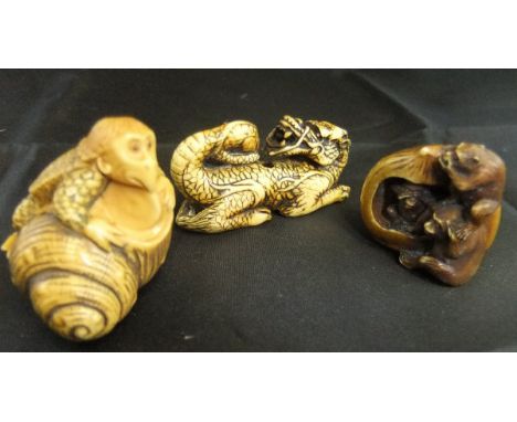 A Japanese carved ivory netsuke as kappa, the water sprite with shell, signed to base, together with another as the three wis