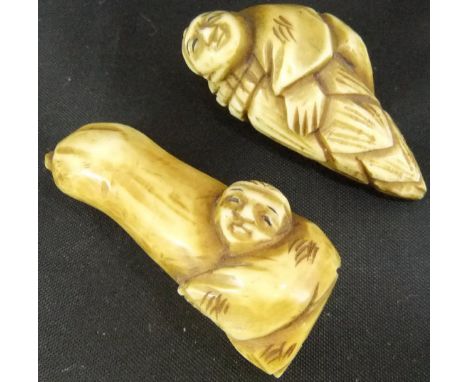 A Japanese carved ivory netsuke as a man hugging a gourd, 4.3cm, and another similar as a man hugging a cob of corn, 4cm (2)