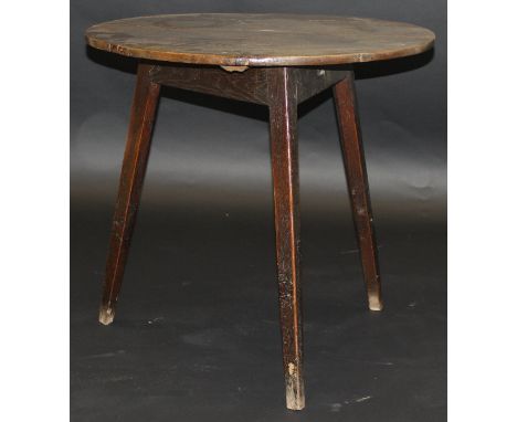 A 19th Century oak cricket table of typical form, the circular top on splayed chamfered supports, 71 cm diameter CONDITION RE