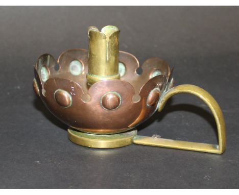 An Arts and Crafts brass and copper chamberstick designed by William Arthur Smith and Benson in the manner of Christopher Dre