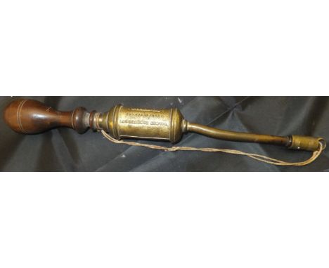 A Victorian cast brass cigar lighter with turned wooden handle, the main gilded shaft inscribed "Wilmot Roberts & Co. Manufac