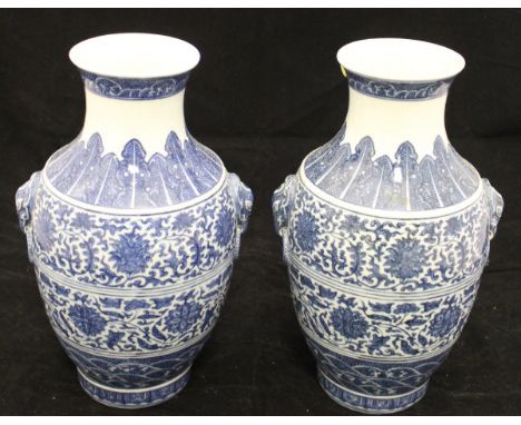A pair of 20th Century Chinese porcelain baluster shaped vases with elephant mask and ring handles, decorated in underglaze b