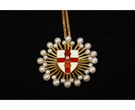 An 18ct gold and seed pearl starburst pendant with central enamel shield depicting the Tudor rose and cross of St George, app