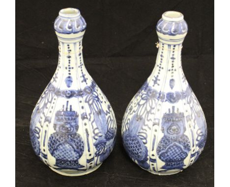 A pair of late 19th / early 20th Century Chinese vases painted in underglaze blue with panels depicting vases, birds amongst 