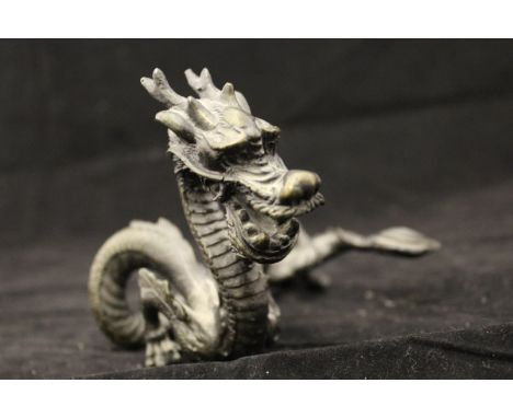 A Chinese cast bronze figure of a four toed dragon, 17 cm long overall