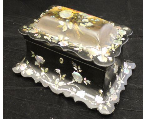 A Victorian black lacquered papier-mache and mother of pearl inlaid tea caddy of swept sarcophagus form, the domed top painte