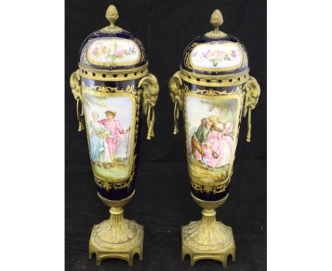 A pair of 19th Centure Sèvres porcelain urns and lids with ormolu and gilt metal mounts and ram's head handles, each raised o