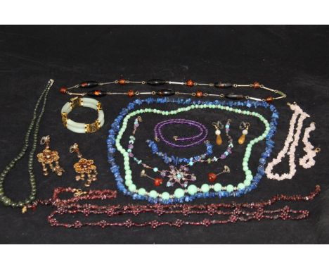 A collection of various costume jewellery, including two amethyst bead necklaces, lapis lazuli bead necklace and matching bra