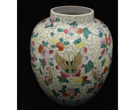 A 20th Century Chinese porcelain vase, polychrome decorated with butterflies amongst blossoming foliage, 35 cm, on an associa