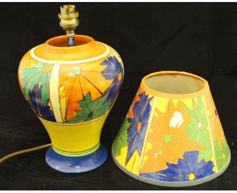 A Clarice Cliff "Fantasque" pattern baluster shaped vase, decorated in yellows, oranges, blue and greens and retailed by Lawl