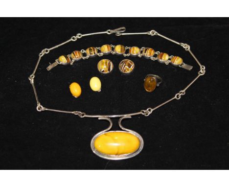 A silver and amber bead necklace, an amber ring, a pair of amber ear clips, and an amber bead bracelet and pair of matching e