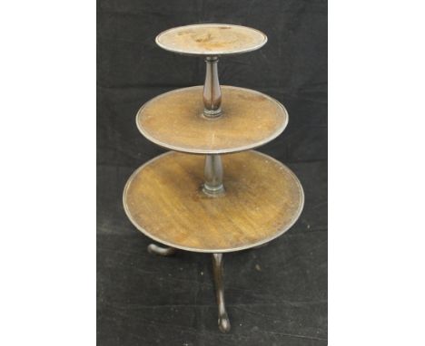 An Edwardian mahogany miniature dumb waiter in the George III taste, each of the three dished tiers interspersed by baluster 
