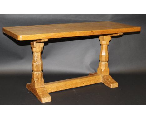A Robert Thompson of Kilburn "The Mouseman" light oak coffee table with a rectangular adzed clock top with rounded corners on