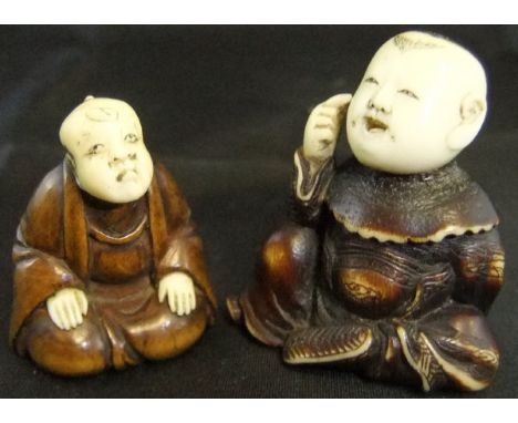 A Japanese carved ivory netsuke as a seated actor with mask behind his back, signed to base, together with another in wood an