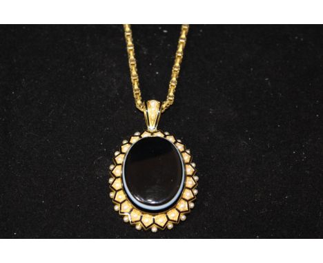 A late Victorian gold coloured seed pearl and enamel pendant, total 28.2g, the front set with an oval cut agate with photogra