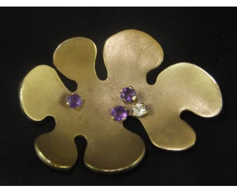 A 9ct gold abstract brooch set with three round cut amethysts and one brilliant cut diamond, by Inborg Bratman, London 1973, 