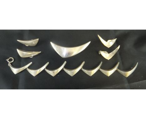 An Aarre & Krough Danish sterling silver brooch of stylised crescent form, together with a pair of matching earrings and brac