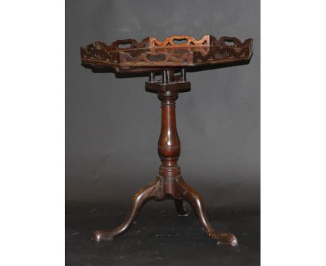 A George III mahogany tea table with octagonal galleried top on a bird cage to a baluster turned pedestal and cabriole tripod