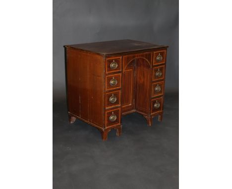 A circa 1800 mahogany kneehole desk, the satinwood cross-banded ebony and satinwood strung top above a recessed cupboard door