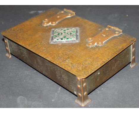 A Guild of Handicrafts copper box with a central diamond shaped motif on a green enamel ground and white metal and foliate pa