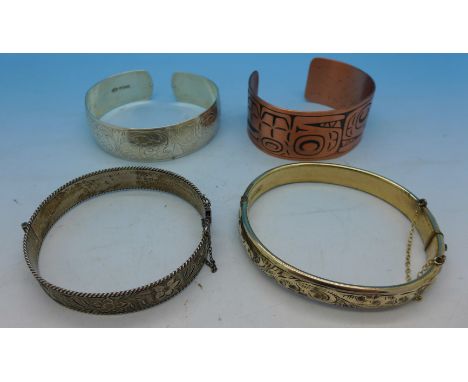 Two silver bangles, 44g, a 9ct gold and metal core bangle and one other