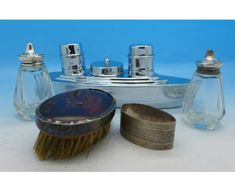 A chrome Art Deco cruet in the form of a ship, a silver topped salt and pepper, a silver and tortoiseshell brush and a silver